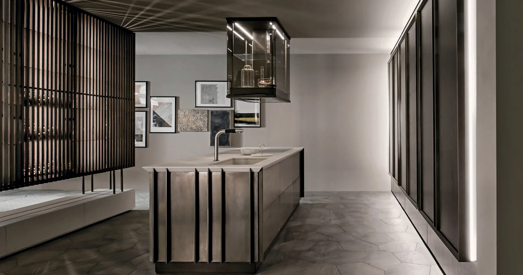 Dark kitchen with a sculpted island, suspended glazed storage and full-height cabinetry
