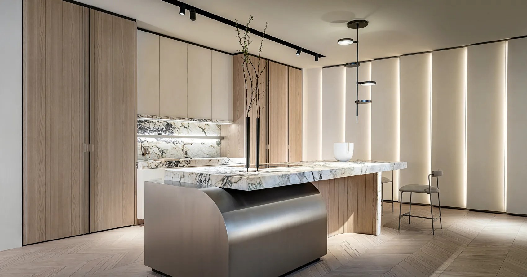 Veined stone kitchen island with a curved metal end, timber cabinetry and illuminated wall panels