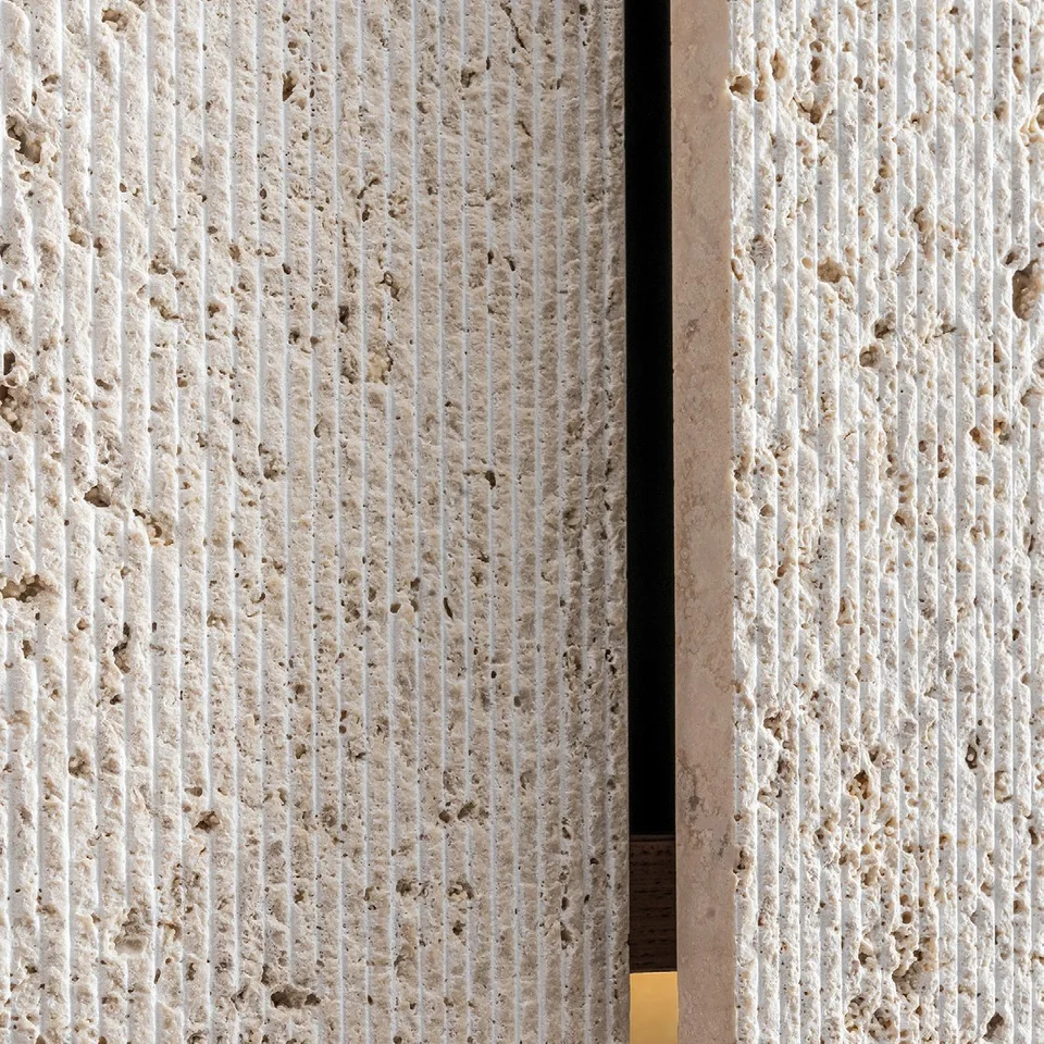 Close-up of travertine texture and the joint between stone cabinet panels